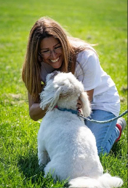 Nancy laughing and playing with her dog Buddy